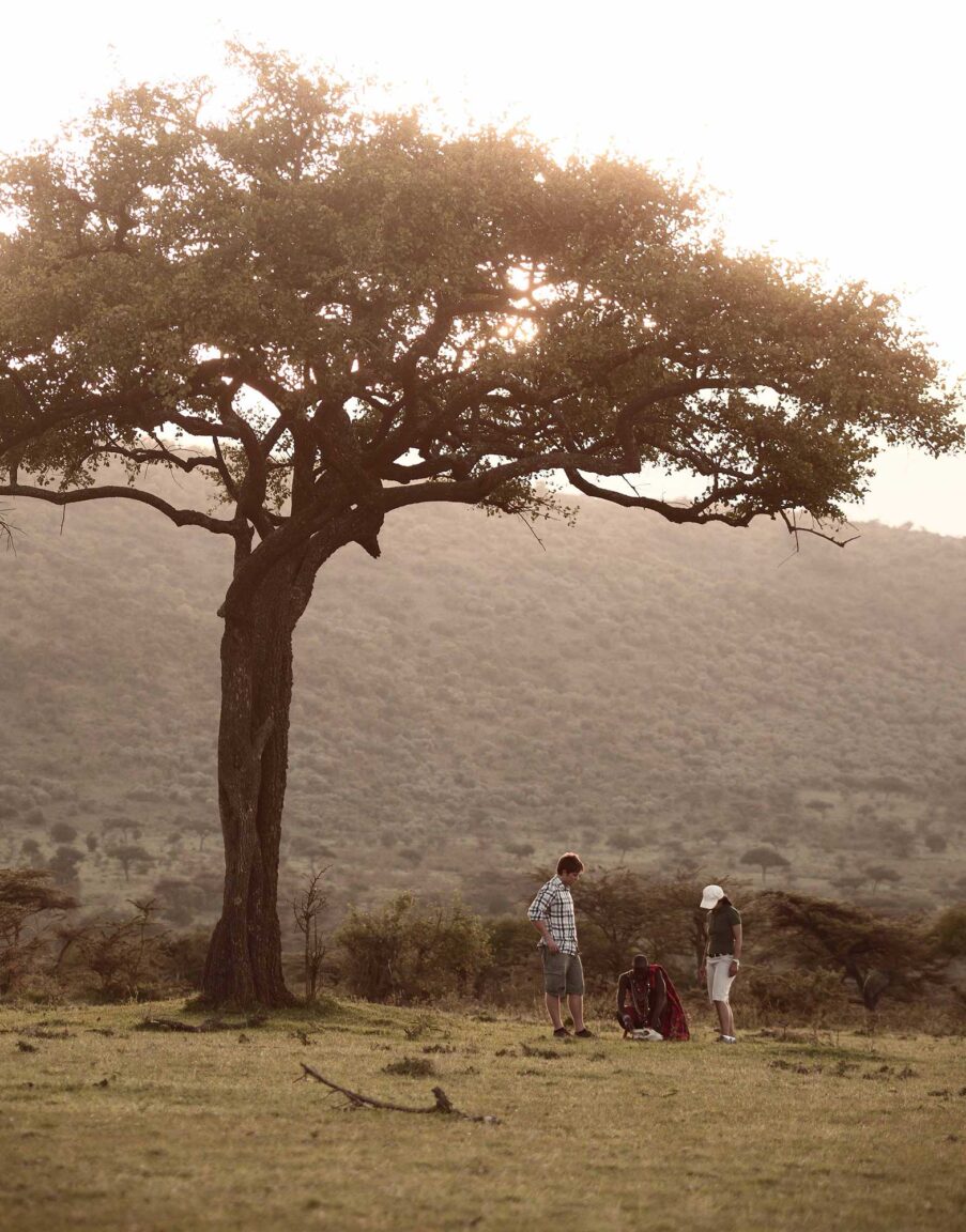 A couple learn about local Mara traditions under a tree