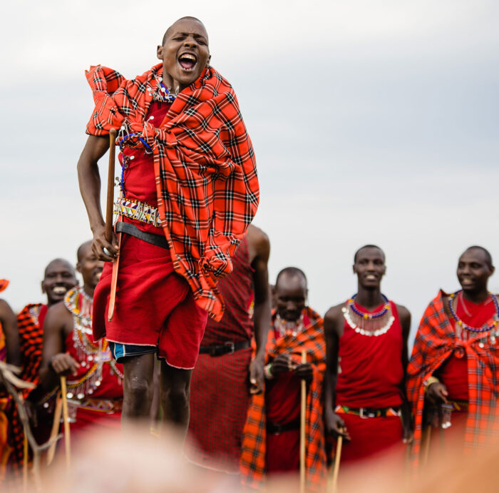 a maasai man performing a renewal ceremony dance