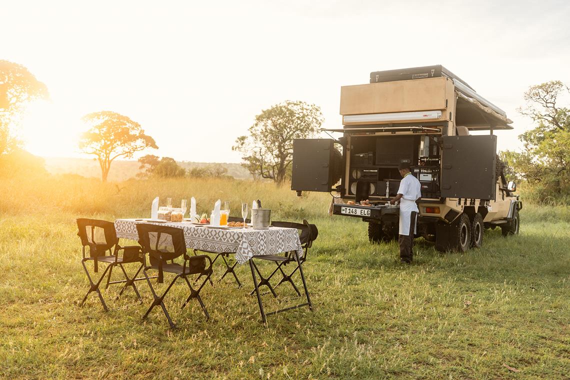 dinner table laid for guests in the plains of Tanzania