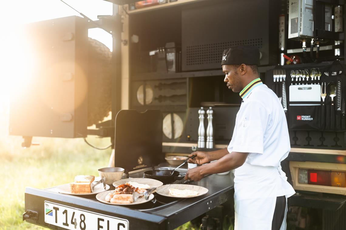 private chef cooking from jeep on roving safari